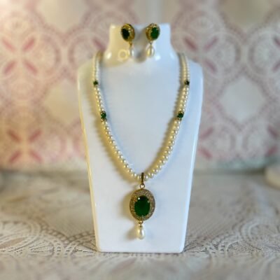 Verdant Glow Pearl Necklace white freshwater pearl necklace and earring set white pearls and green gems green synthetic onyx stone pendant with a white pearl dangling below and matching earrings